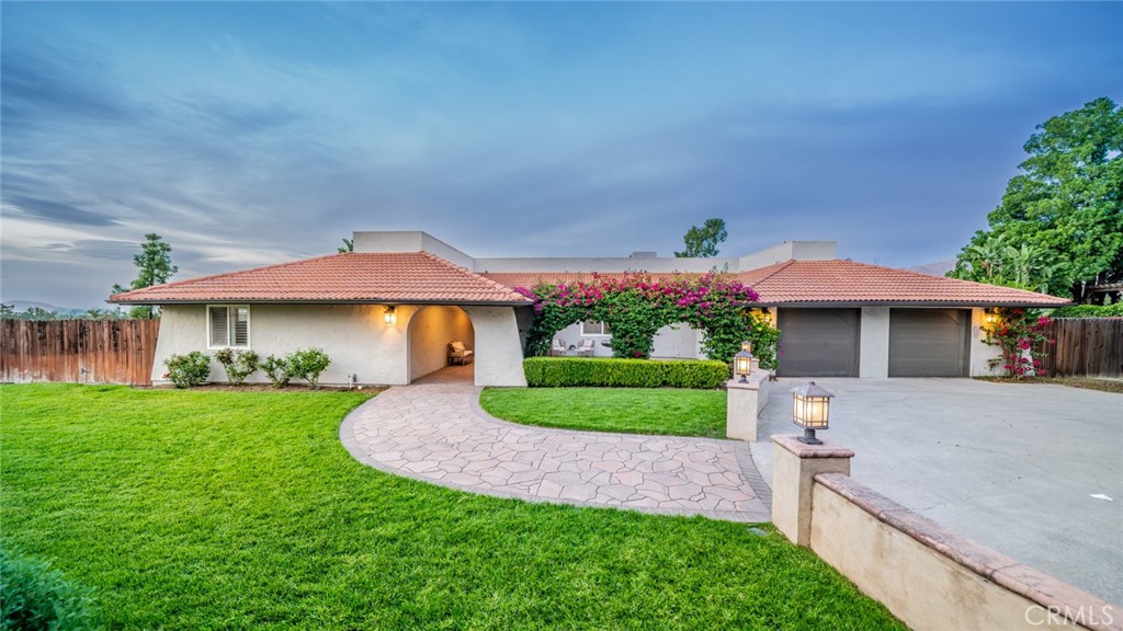 5300 Vía San Jacinto Riverside, CA 92506 - Photo 4 of 59 a front view of a house with a yard and potted plants