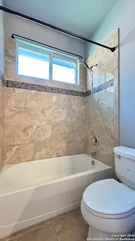 a bathroom with a toilet and a bathtub