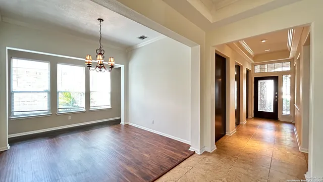 a view of a room with window wooden floor and chandelier