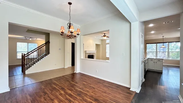 a view of a livingroom with wooden floor and a chandelier