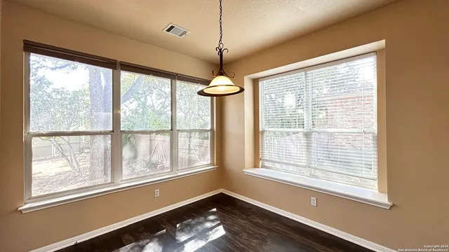 a view of an empty room with windows