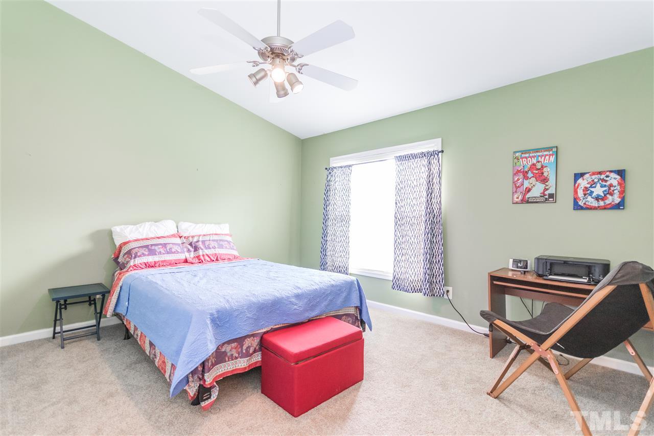 2131 Piney Brook Road, Unit 103 Raleigh, NC 27614 - Photo 14 of 18 a bedroom with a bed and a chandelier