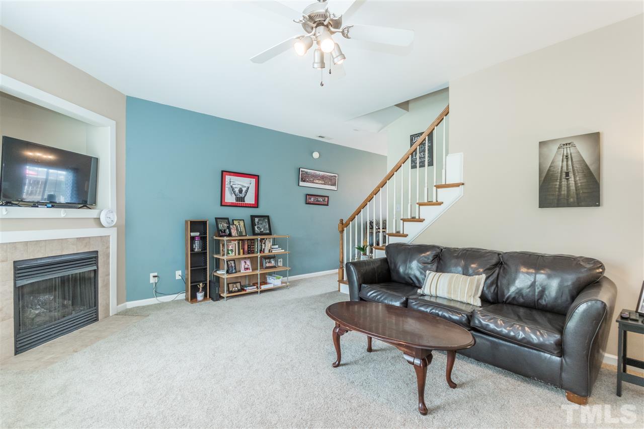 2131 Piney Brook Road, Unit 103 Raleigh, NC 27614 - Photo 3 of 18 a living room with furniture and a fireplace
