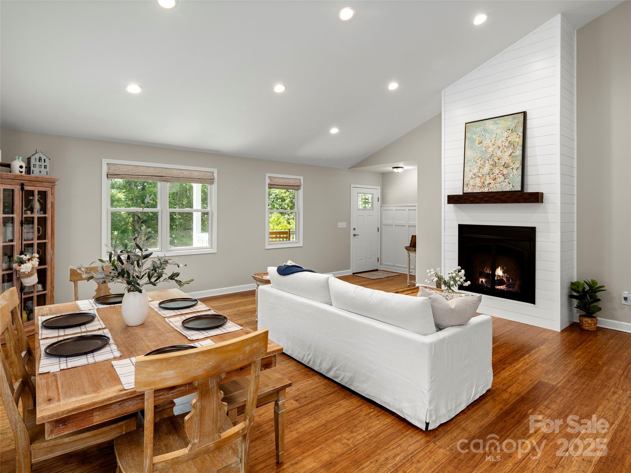 269 Adams Drive Clyde, NC 28721 - Photo 11 of 32 a living room with furniture a fireplace and a large window
