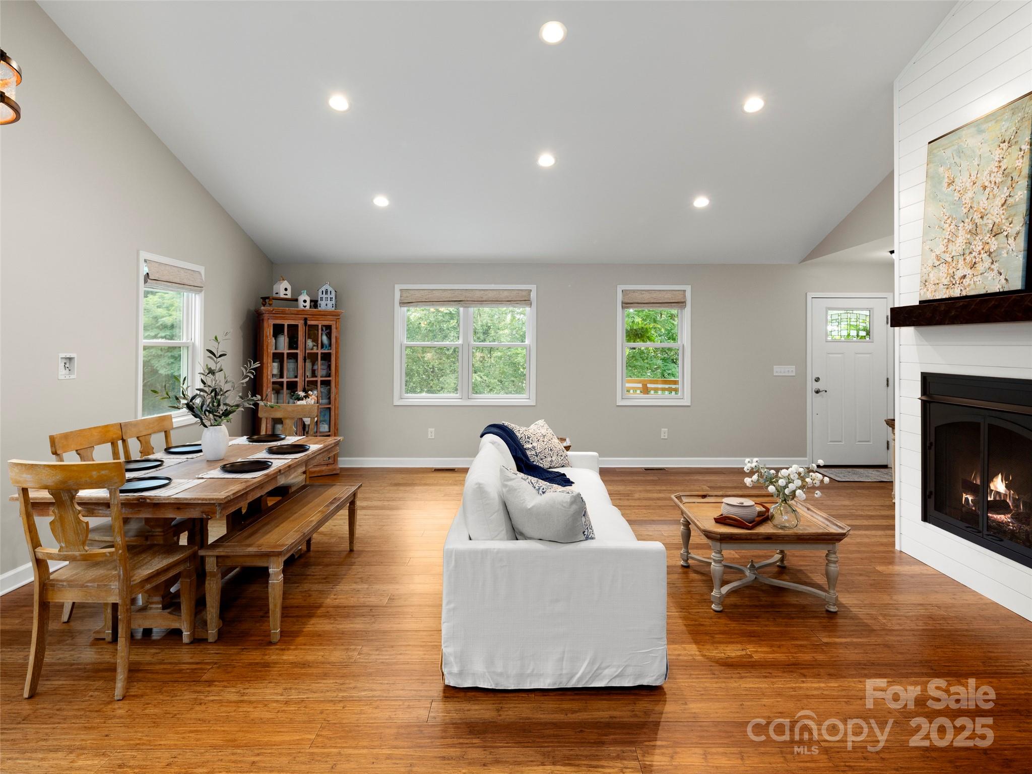269 Adams Drive Clyde, NC 28721 - Photo 12 of 32 a living room with furniture a fireplace and a flat screen tv