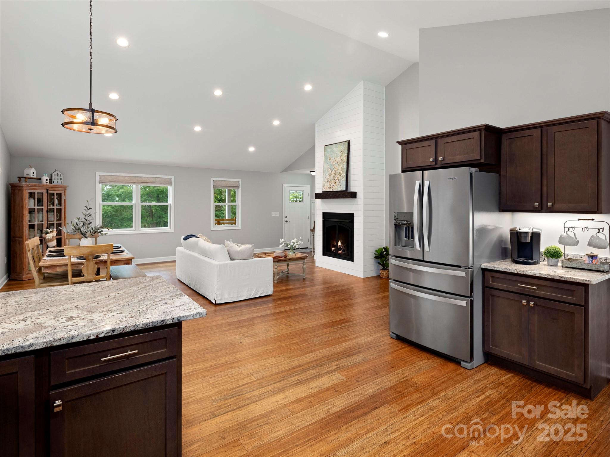 269 Adams Drive Clyde, NC 28721 - Photo 15 of 32 a kitchen with stainless steel appliances granite countertop a refrigerator a sink dishwasher a oven with a dining table and chairs