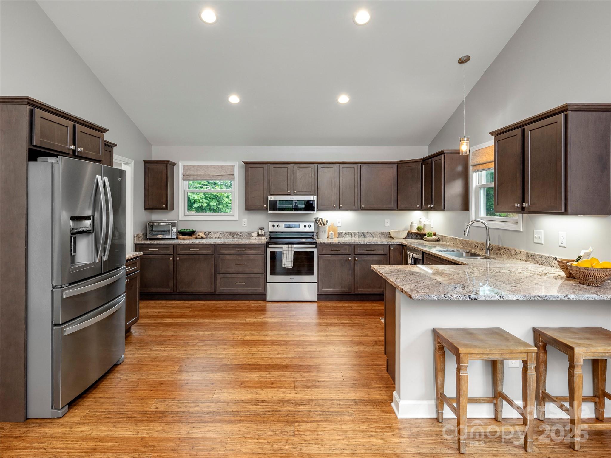 269 Adams Drive Clyde, NC 28721 - Photo 16 of 32 a kitchen with kitchen island granite countertop wooden cabinets and stainless steel appliances