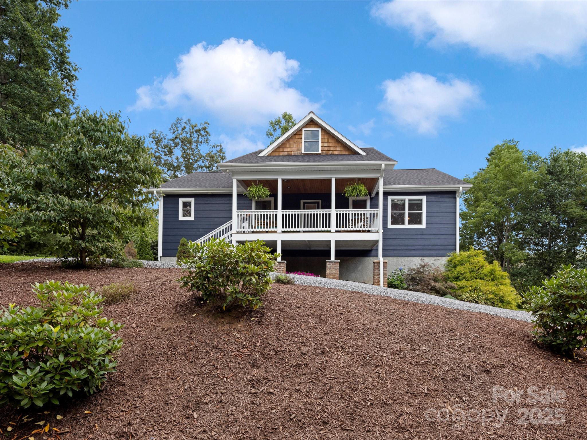 269 Adams Drive Clyde, NC 28721 - Photo 2 of 32 a front view of a house with garden