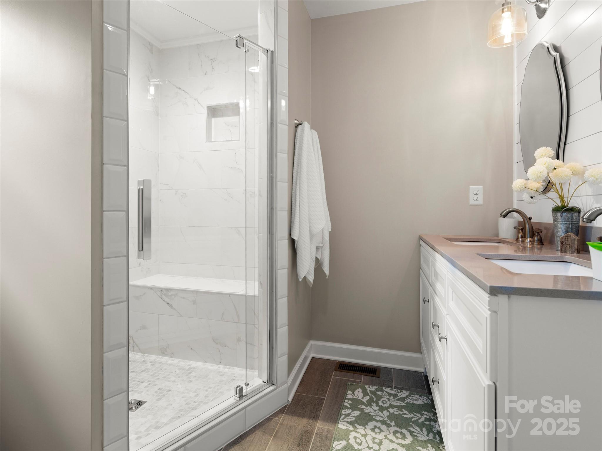 269 Adams Drive Clyde, NC 28721 - Photo 21 of 32 a bathroom with a sink a light fixture and a glass door with a mirror