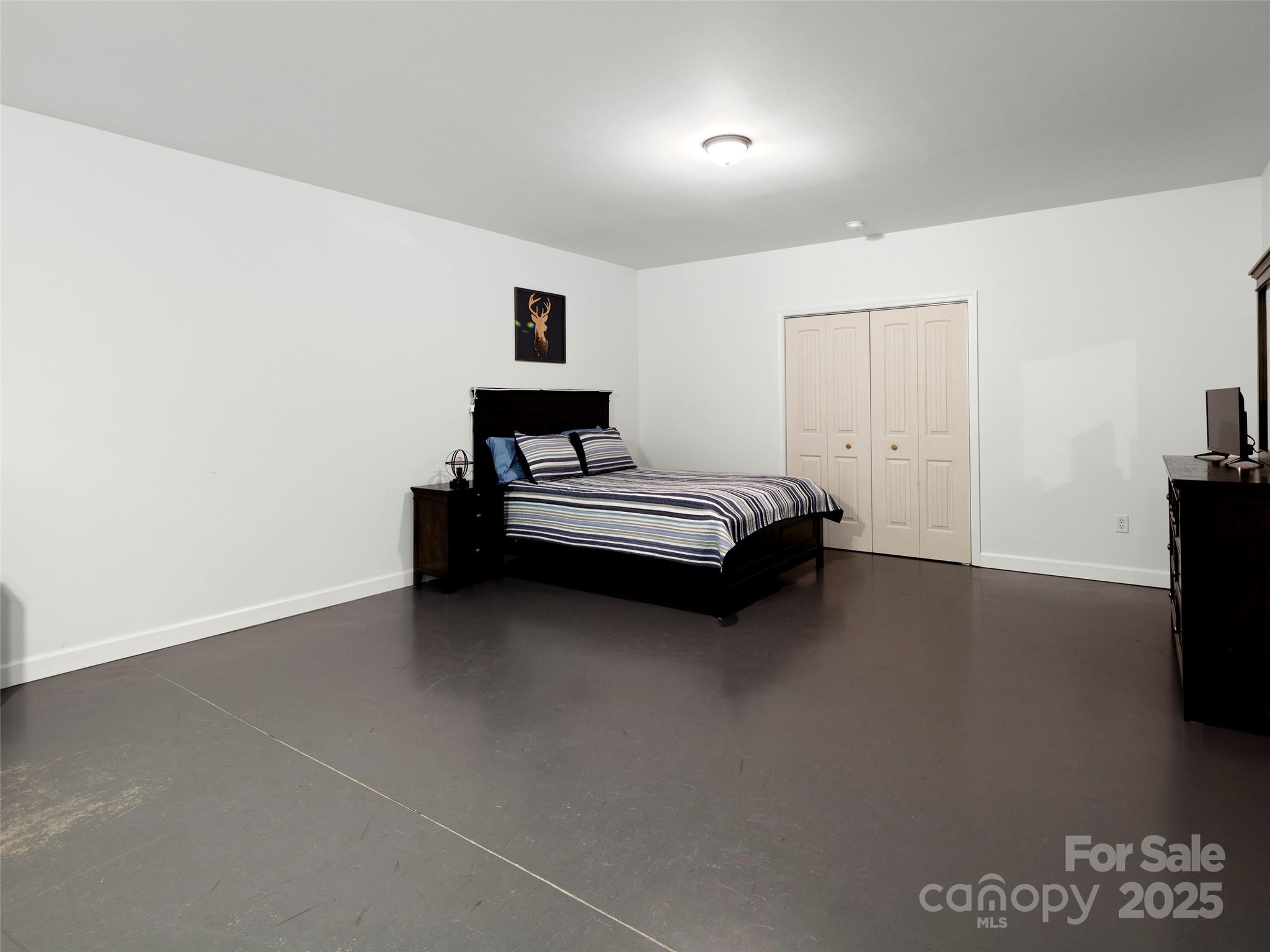 269 Adams Drive Clyde, NC 28721 - Photo 26 of 32 a bedroom with a bed and a tv