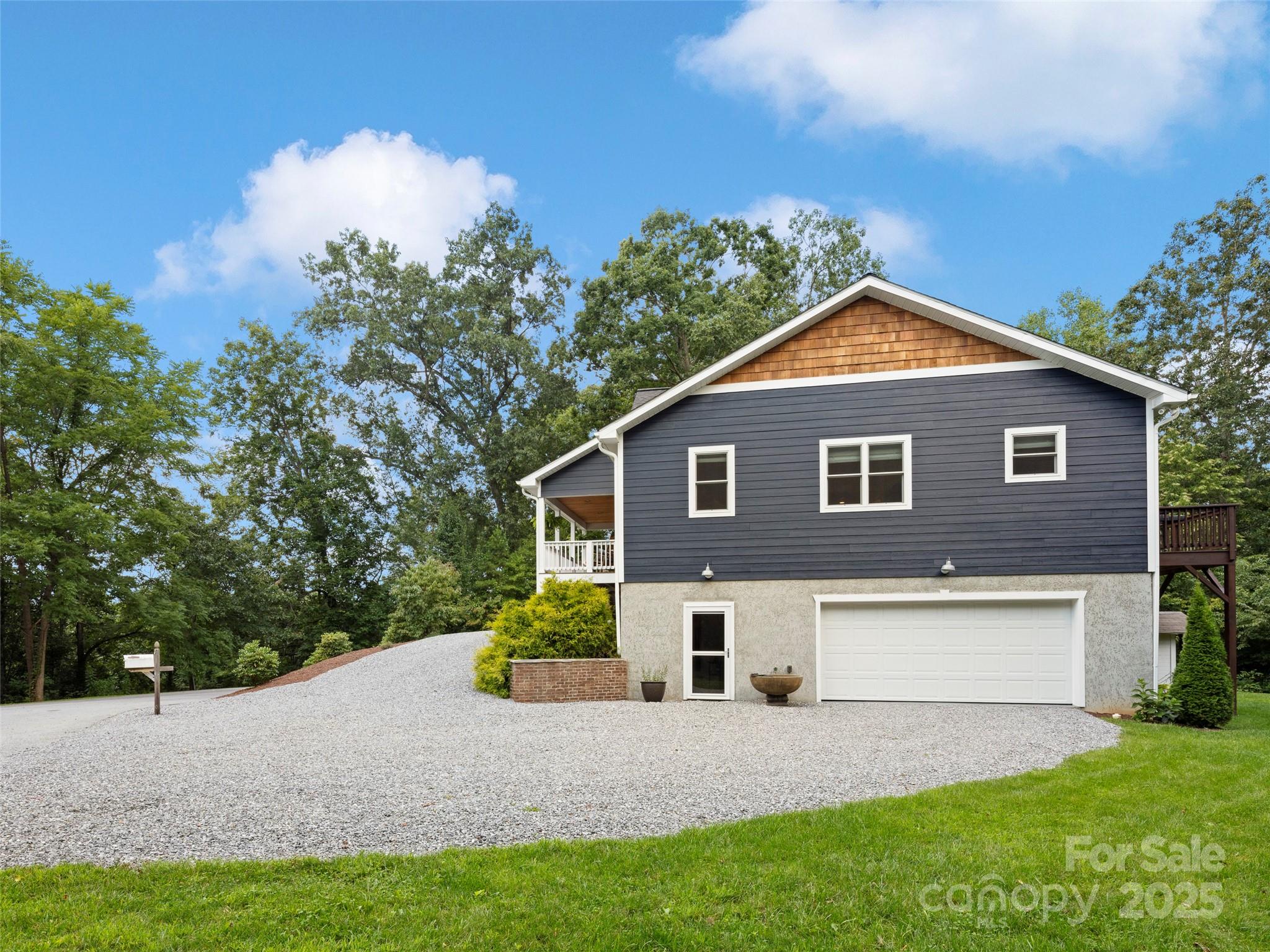 269 Adams Drive Clyde, NC 28721 - Photo 29 of 32 a front view of a house with a yard and garage