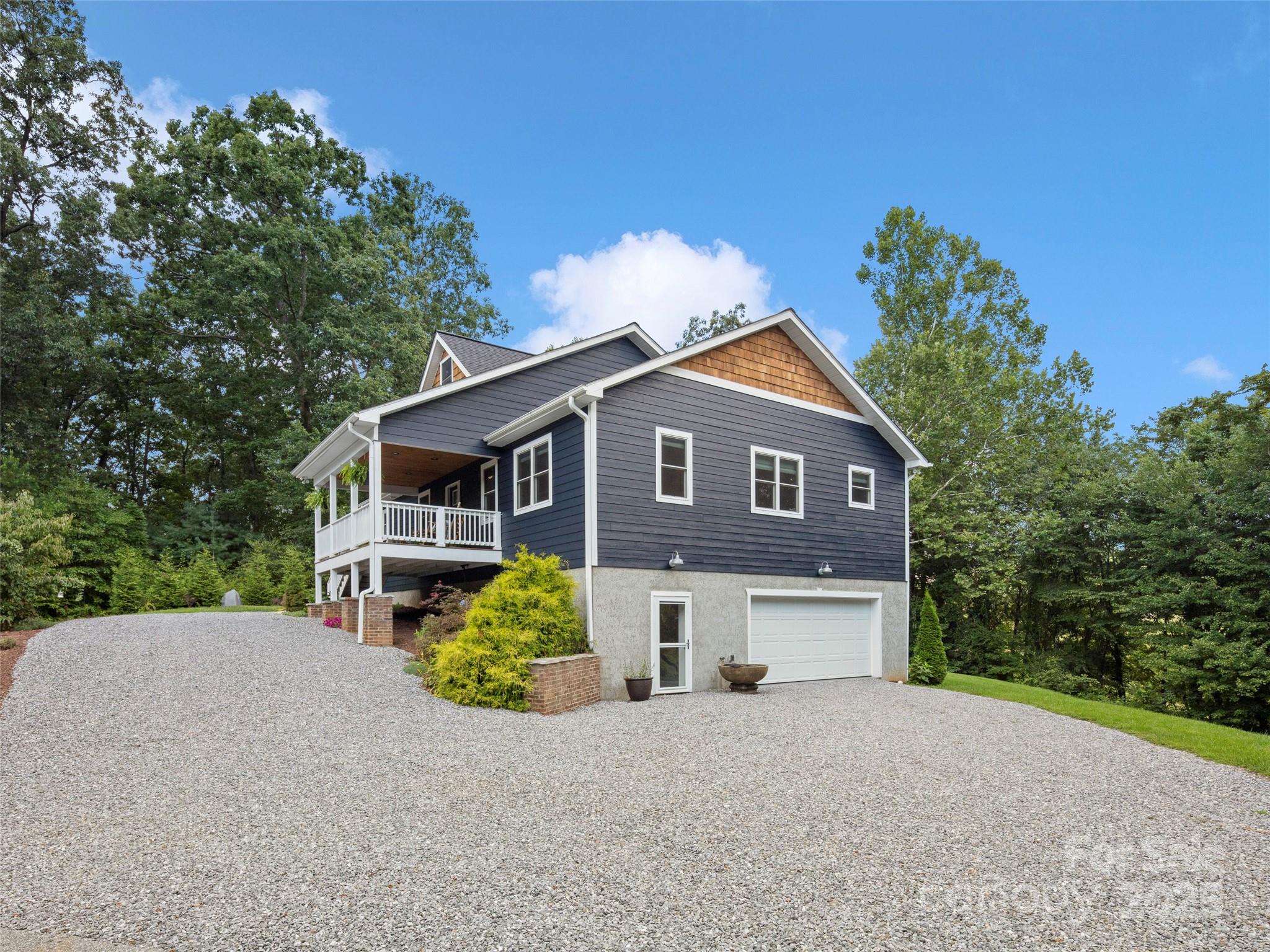 269 Adams Drive Clyde, NC 28721 - Photo 3 of 32 a front view of a house with a yard and garage