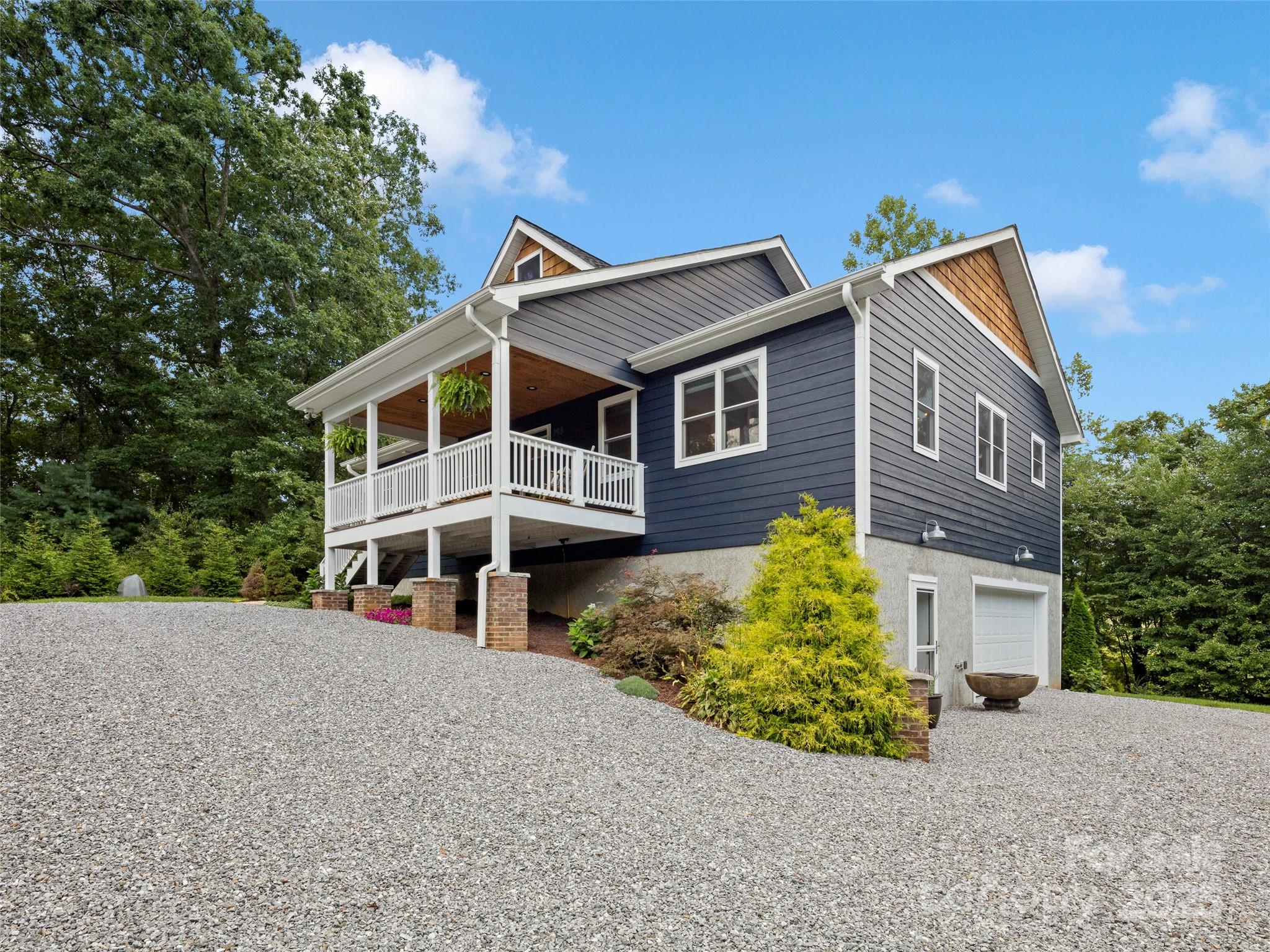 269 Adams Drive Clyde, NC 28721 - Photo 4 of 32 a front view of a house with a yard