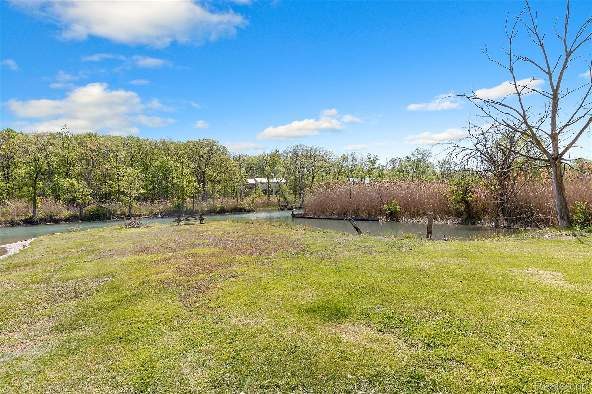 22827 Meridian Road Grosse Ile, MI 48138 - Photo 10 of 36 View of green lawn with a water view