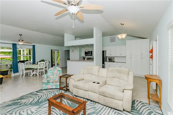 a living room with furniture and kitchen view