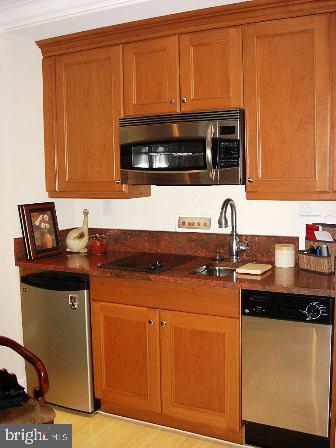 1701 Locust Street, Unit 1717 Philadelphia, PA 19103 - Photo 2 of 13 a kitchen with stainless steel appliances granite countertop a sink stove and microwave