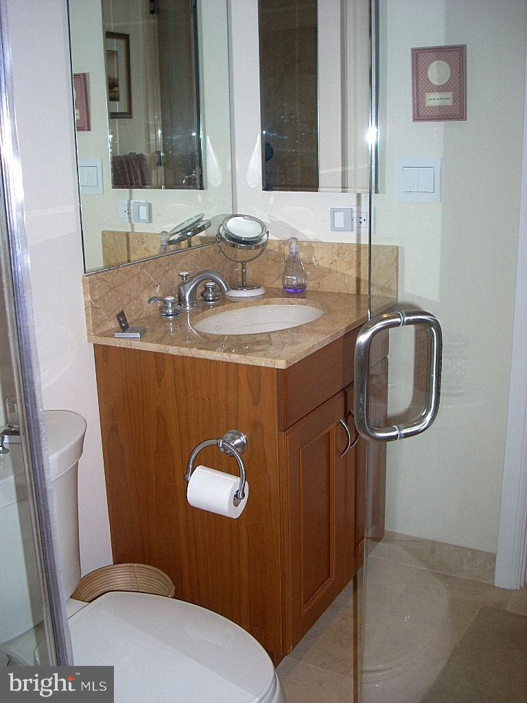 1701 Locust Street, Unit 1717 Philadelphia, PA 19103 - Photo 3 of 13 a bathroom with a sink toilet and mirror