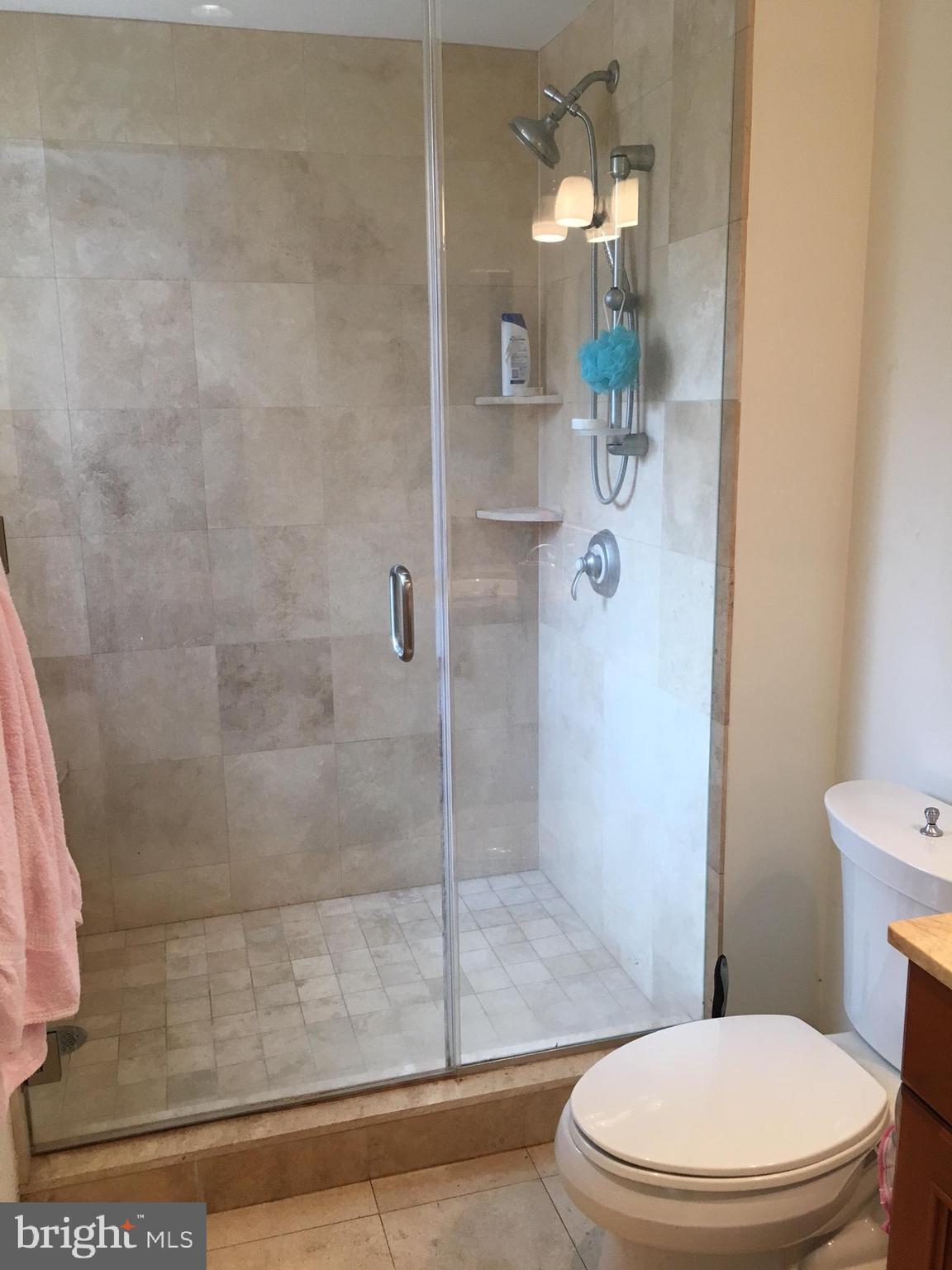 1701 Locust Street, Unit 1717 Philadelphia, PA 19103 - Photo 4 of 13 a white toilet next to a bathroom