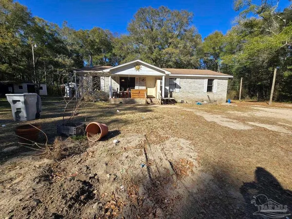 a view of a house with backyard and sitting area
