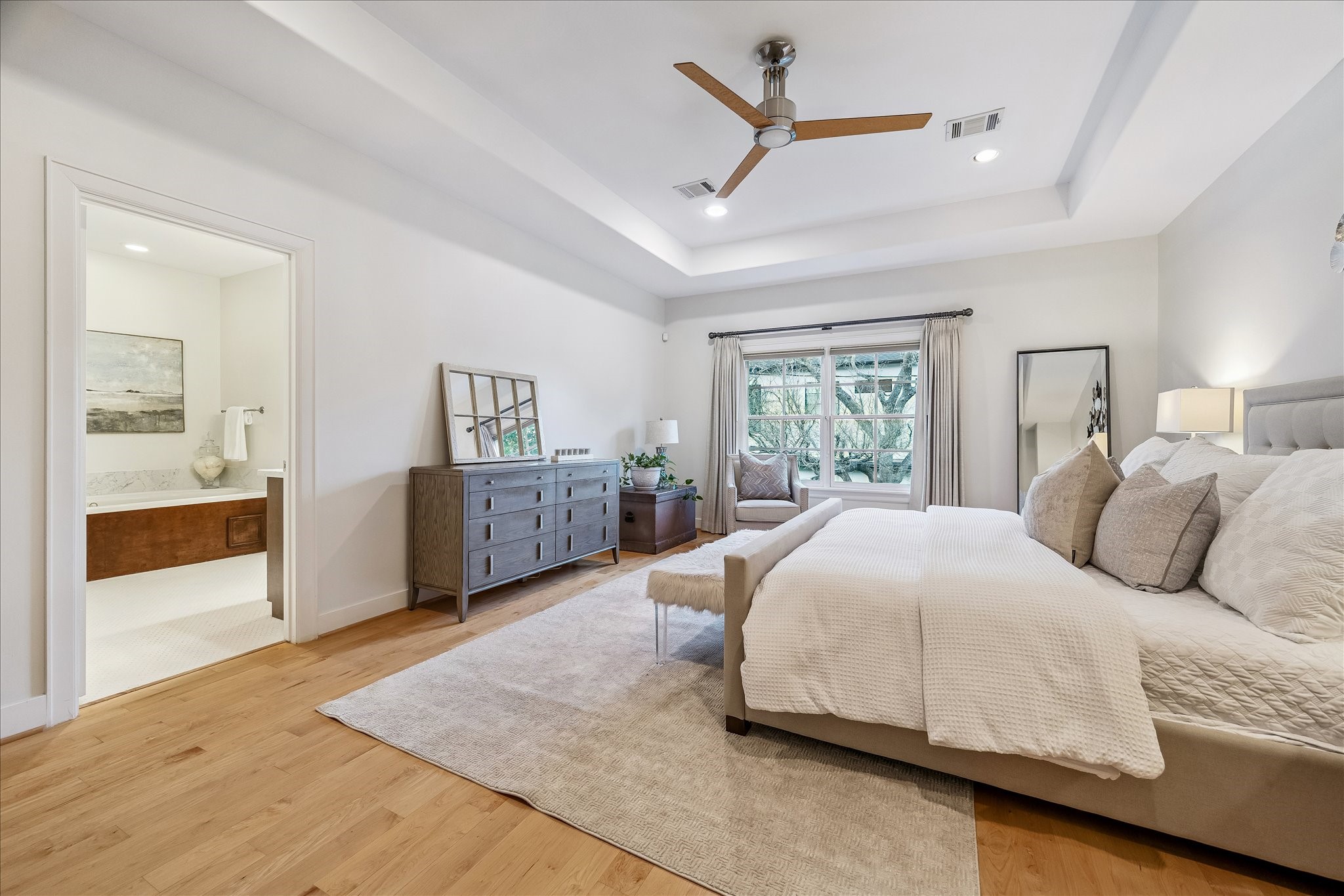 4010 Milton Street Houston, TX 77005 - Photo 21 of 49 PRIMARY. Note the tray ceiling, hardwood floors, and large windows.