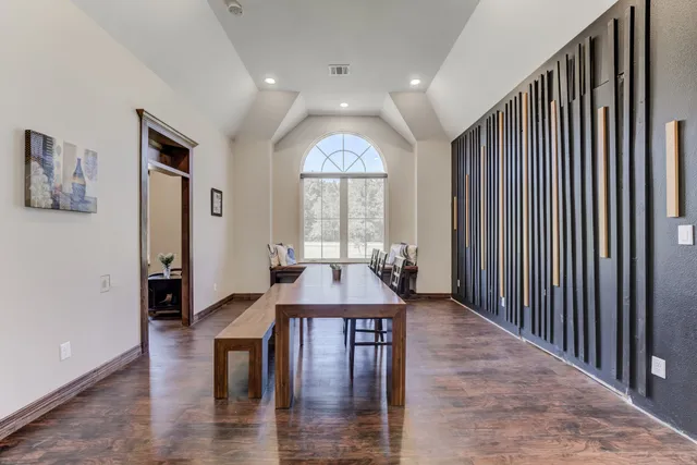 a view of a a dining room with furniture window and wooden floor
