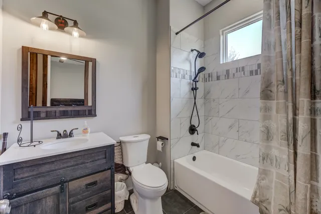 a bedroom with a bed and a large window