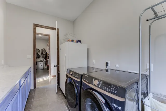 a view of a big house with a big yard and large trees