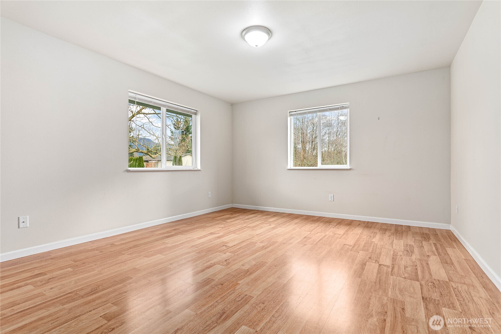 303 Hayes Street Nooksack, WA 98276 - Photo 28 of 40 a view of an empty room with wooden floor and a window