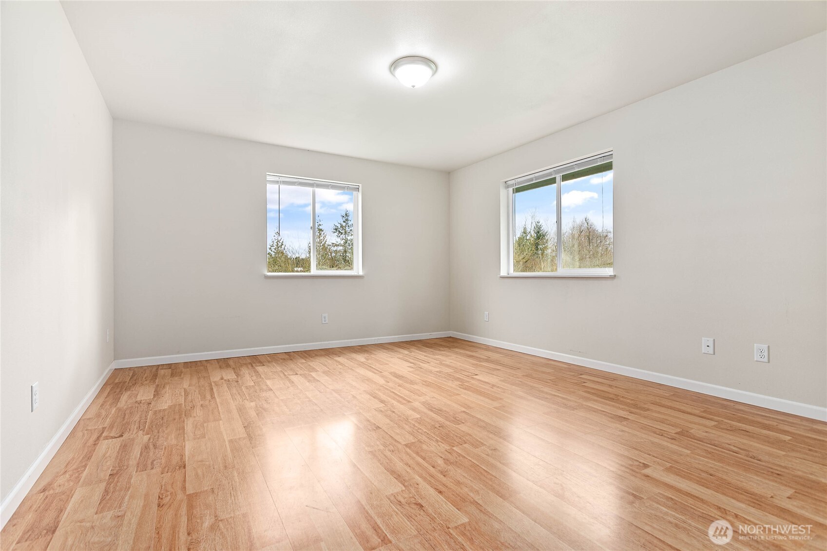 303 Hayes Street Nooksack, WA 98276 - Photo 30 of 40 an empty room with wooden floor and windows