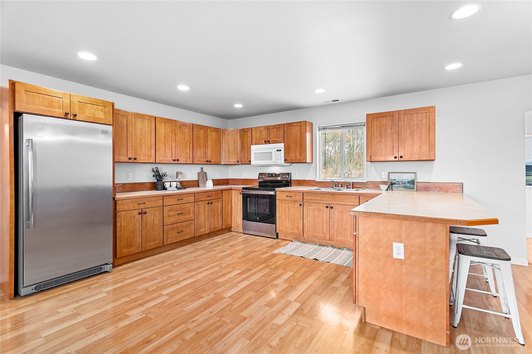 303 Hayes Street Nooksack, WA 98276 - Photo 7 of 40 a kitchen with stainless steel appliances granite countertop a refrigerator sink and cabinets