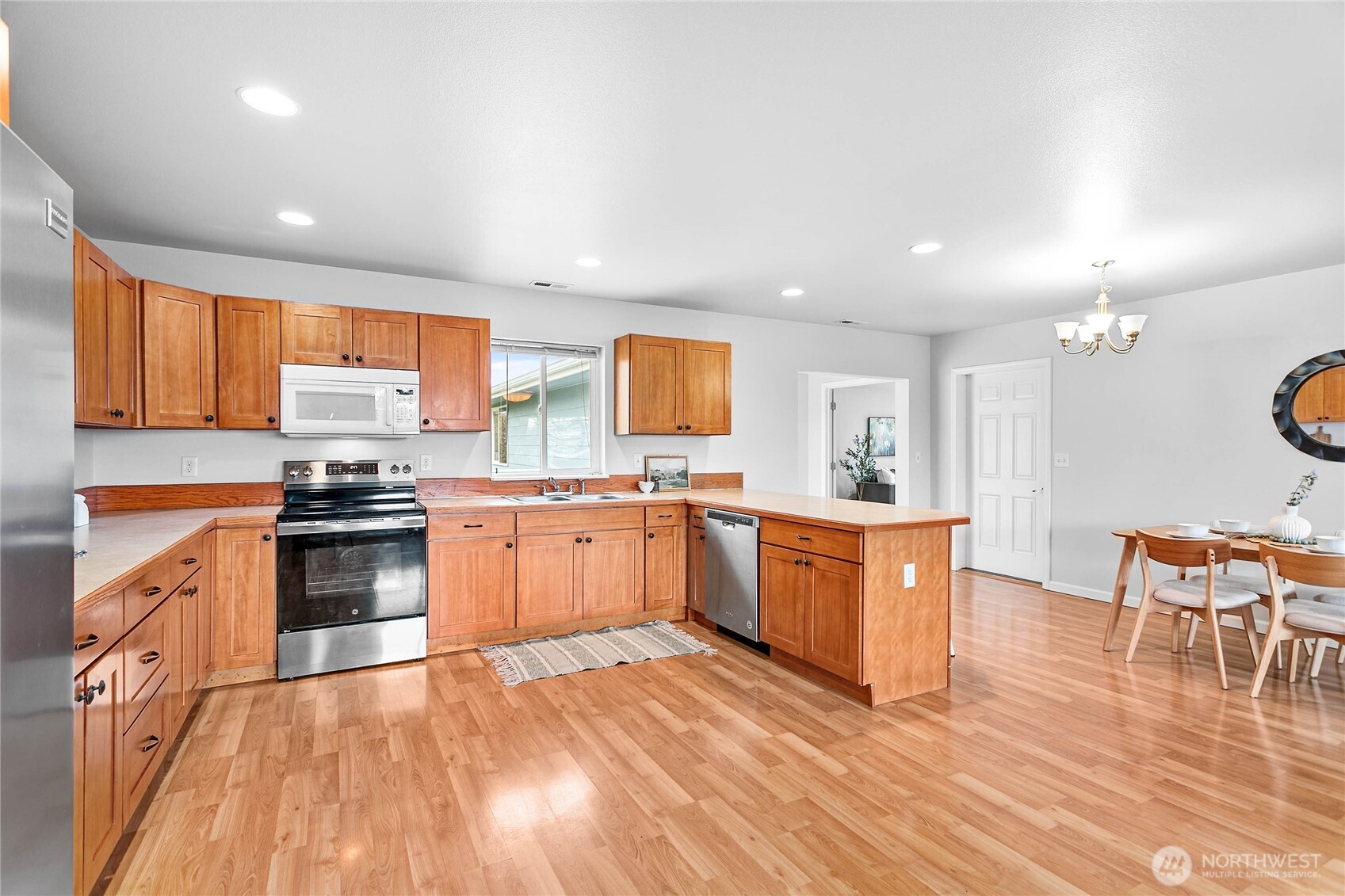 303 Hayes Street Nooksack, WA 98276 - Photo 9 of 40 a large kitchen with stainless steel appliances granite countertop a stove and a wooden floors