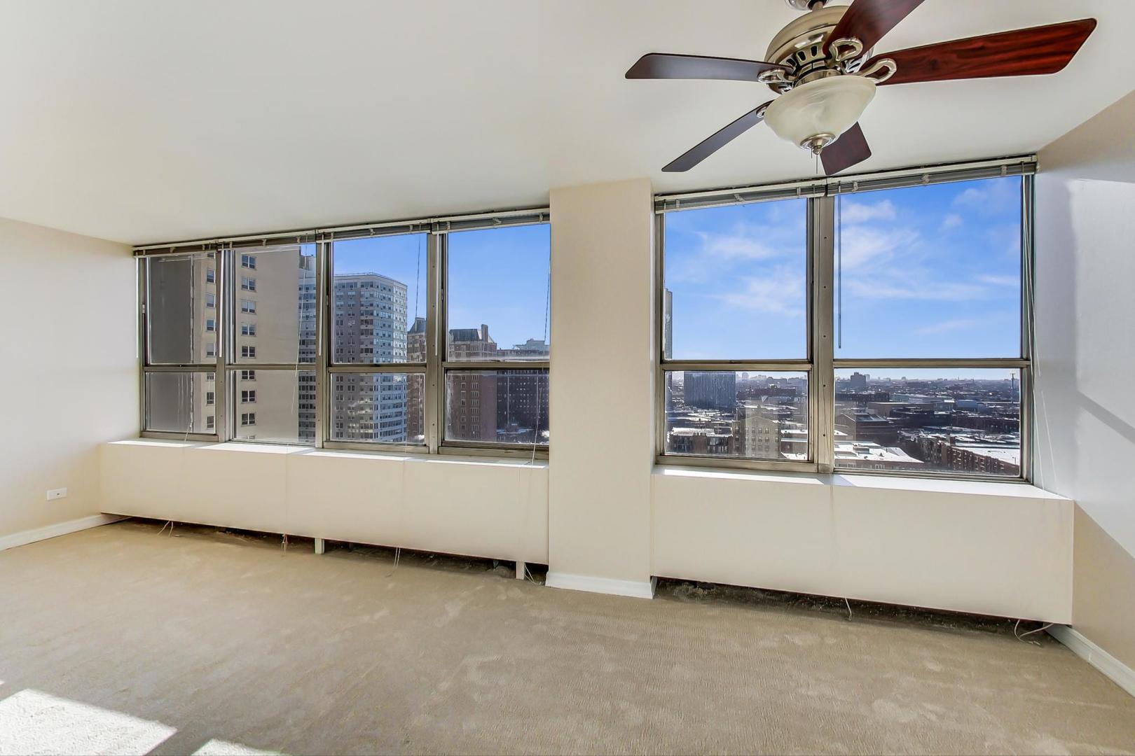 655 West Irving Park Road, Unit 1403 Chicago, IL 60613 - Photo 11 of 36 a living room with furniture and a window