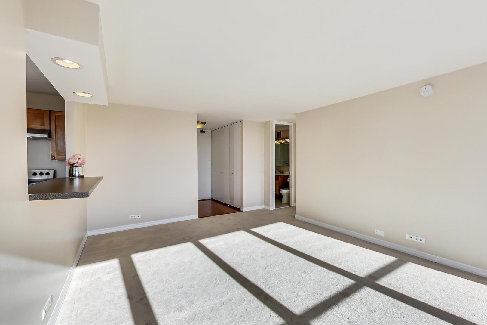 655 West Irving Park Road, Unit 1403 Chicago, IL 60613 - Photo 12 of 36 a bedroom with a bed and a mirror