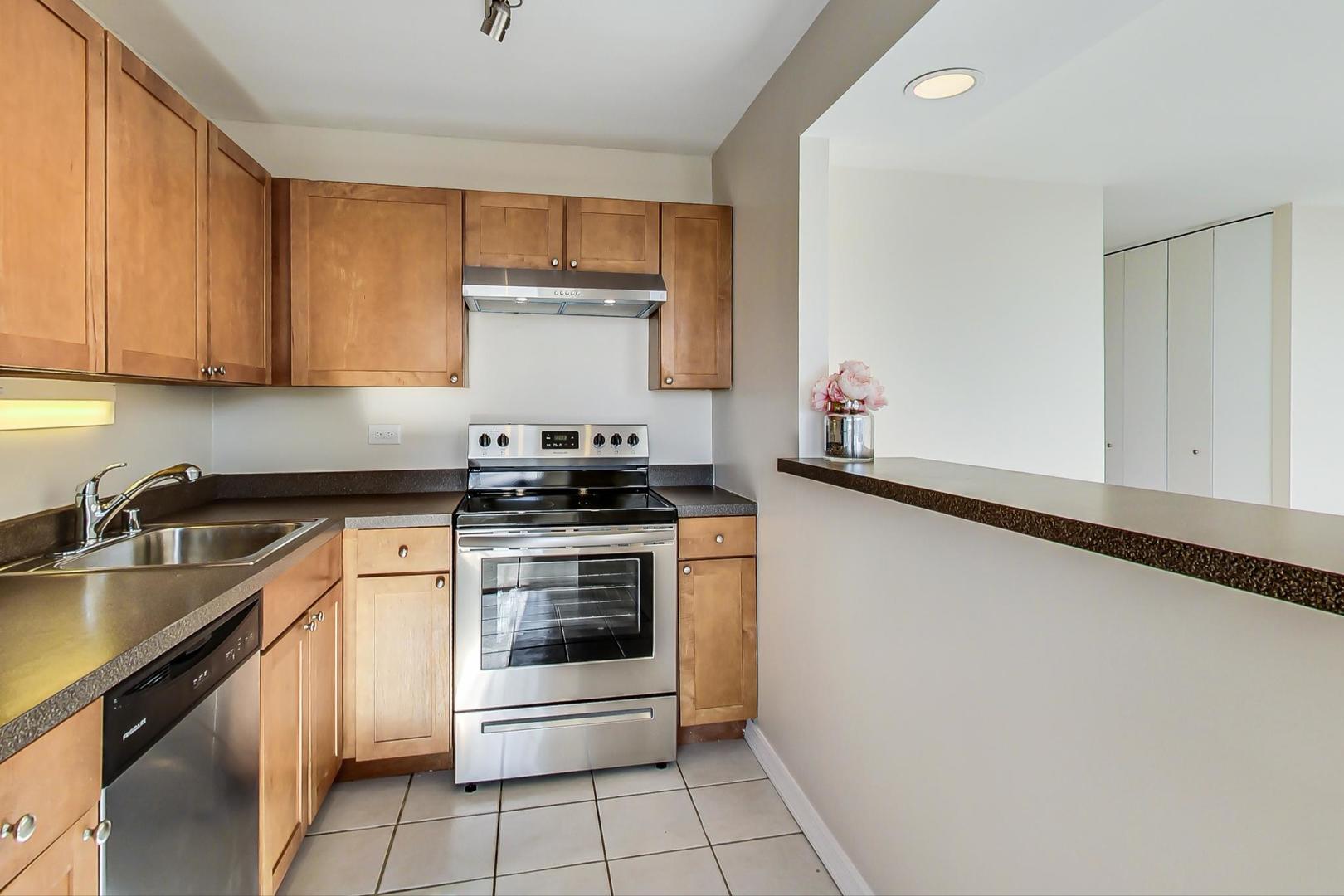 655 West Irving Park Road, Unit 1403 Chicago, IL 60613 - Photo 16 of 36 a kitchen with a stove and a sink