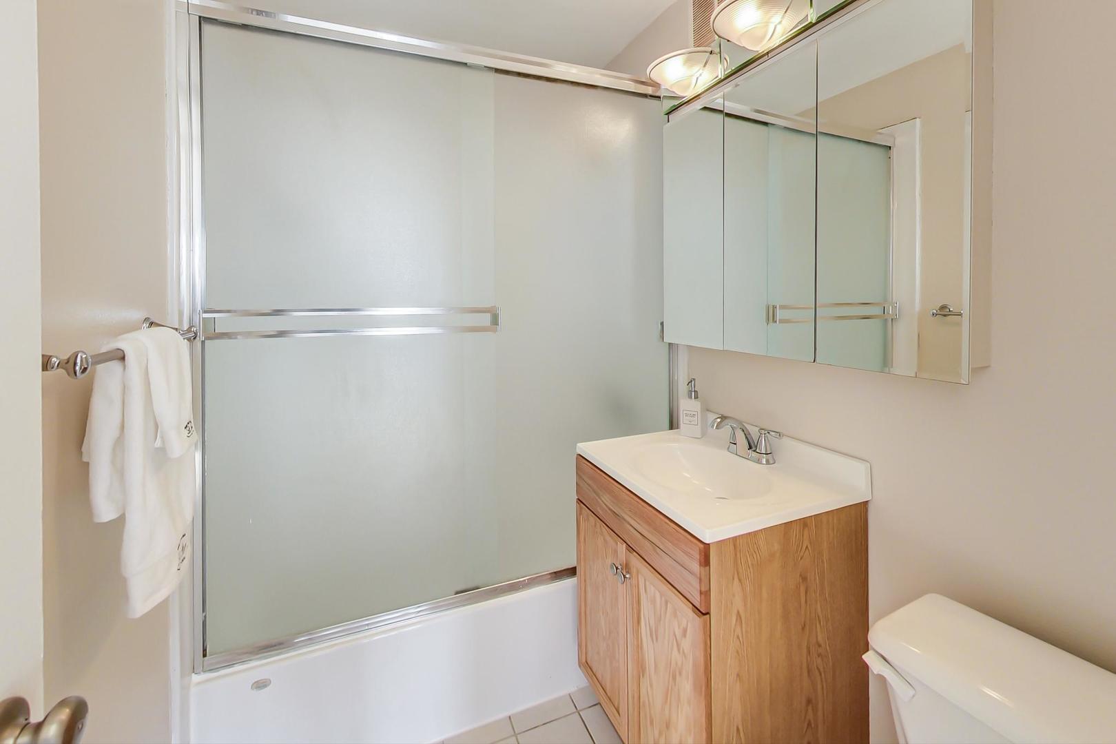 655 West Irving Park Road, Unit 1403 Chicago, IL 60613 - Photo 18 of 36 a bathroom with a sink a toilet and shower