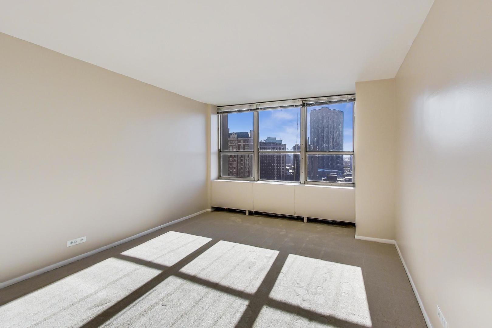655 West Irving Park Road, Unit 1403 Chicago, IL 60613 - Photo 19 of 36 a view of an empty room with a window