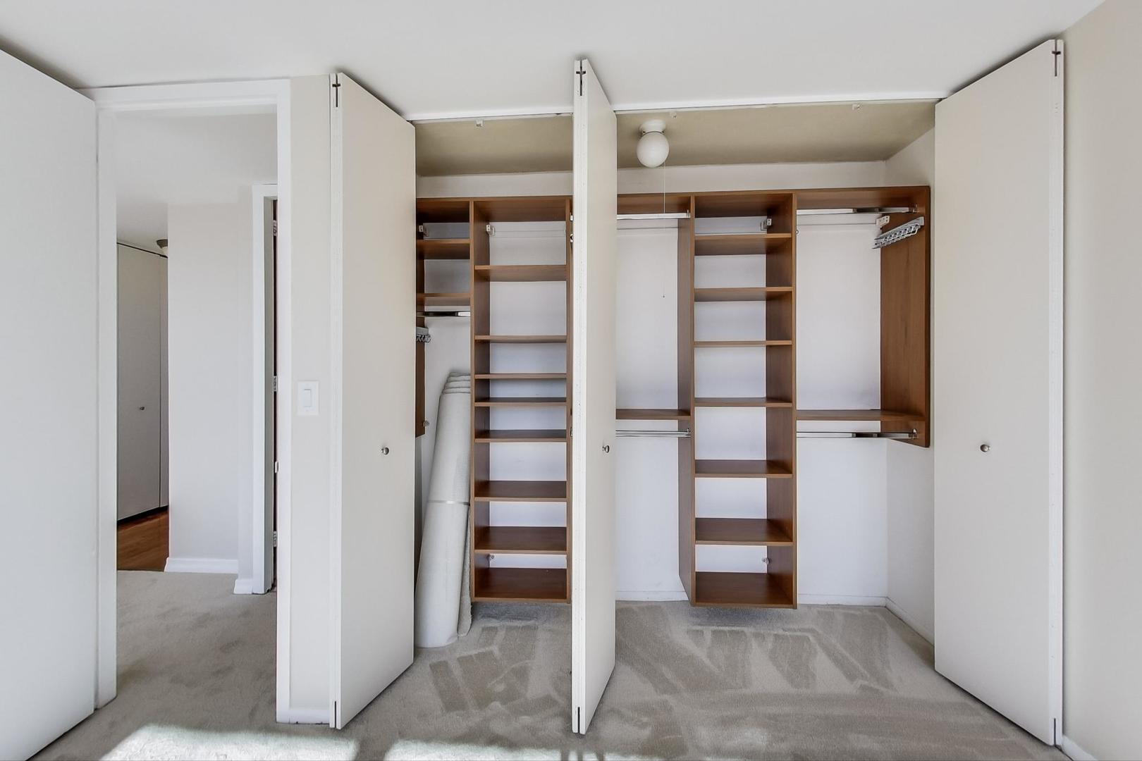 655 West Irving Park Road, Unit 1403 Chicago, IL 60613 - Photo 21 of 36 a view of walk in closet with empty racks