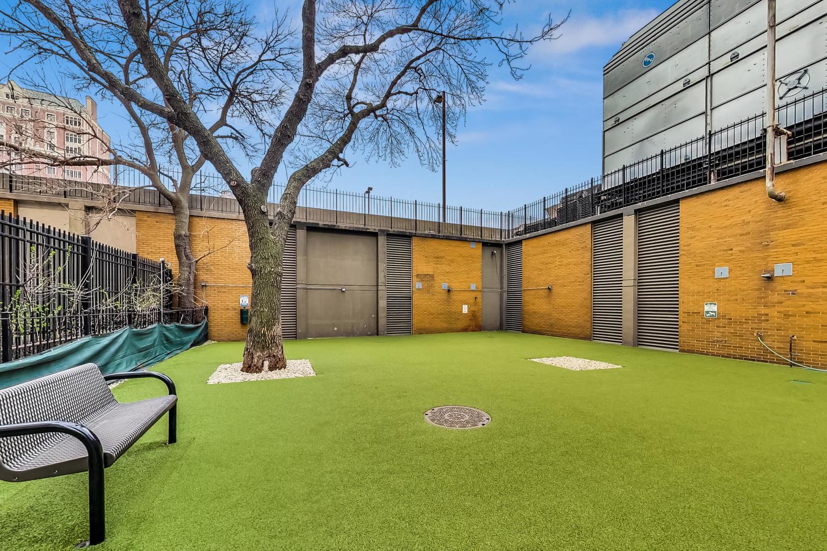 655 West Irving Park Road, Unit 1403 Chicago, IL 60613 - Photo 35 of 36 a view of a backyard with a table and chair