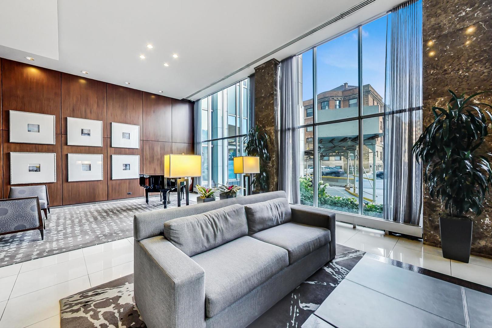 655 West Irving Park Road, Unit 1403 Chicago, IL 60613 - Photo 5 of 36 a living room with furniture and a potted plant