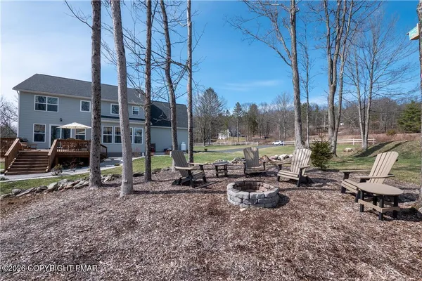 a view of a park with lawn chairs and a fire pit