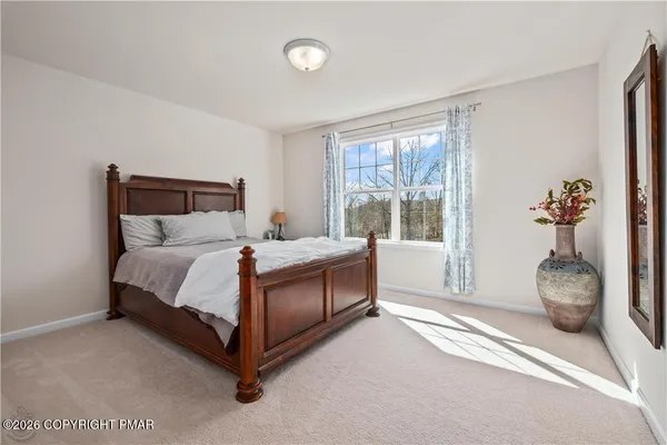 a bed room with a bed and a large window