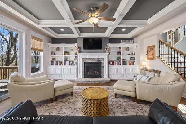 a living room with furniture a flat screen tv and a fireplace