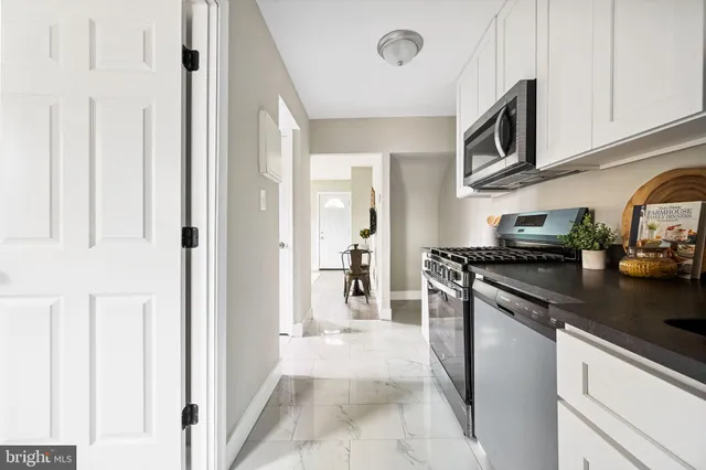 a kitchen with stainless steel appliances granite countertop a refrigerator and a sink