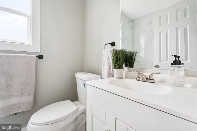 a bathroom with a toilet sink and mirror