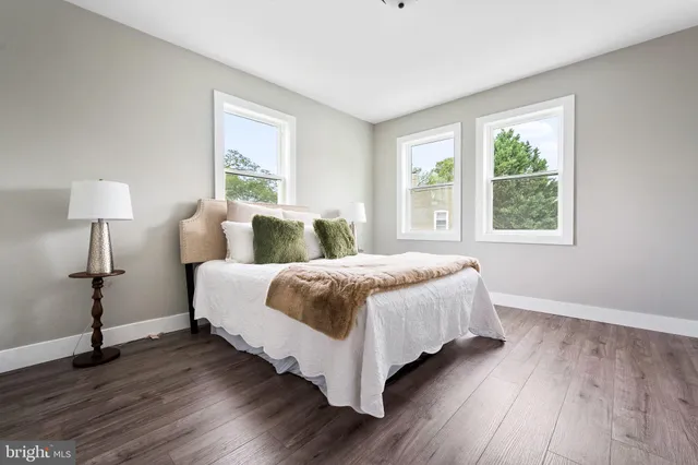 a spacious bedroom with a bed and a window