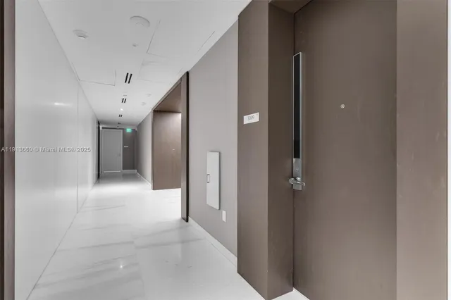 a living room with furniture and large windows