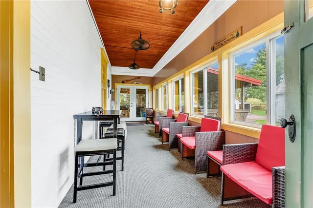 a living room with furniture a chandelier and a dining table