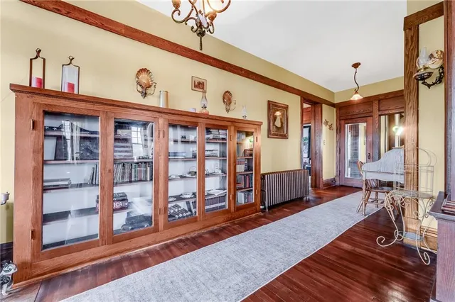 a dining room with furniture a chandelier and pool table