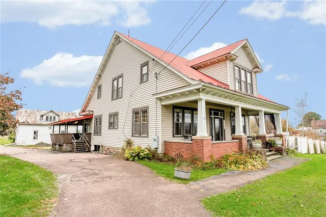 a front view of a house with a yard table and chairs
