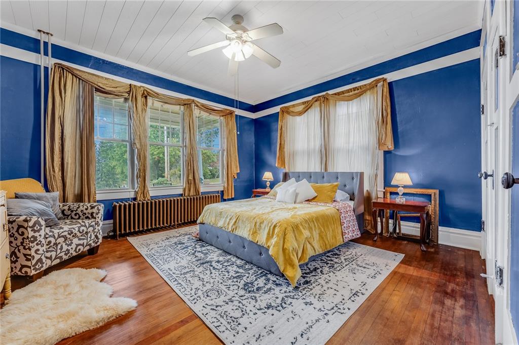 539 Main Street Addison, PA 15411 - Photo 34 of 50 a bedroom with a large bed and a chandelier